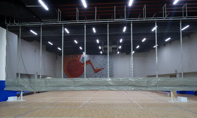 Indoor sports hall at Oberoi International School — seating and run-off